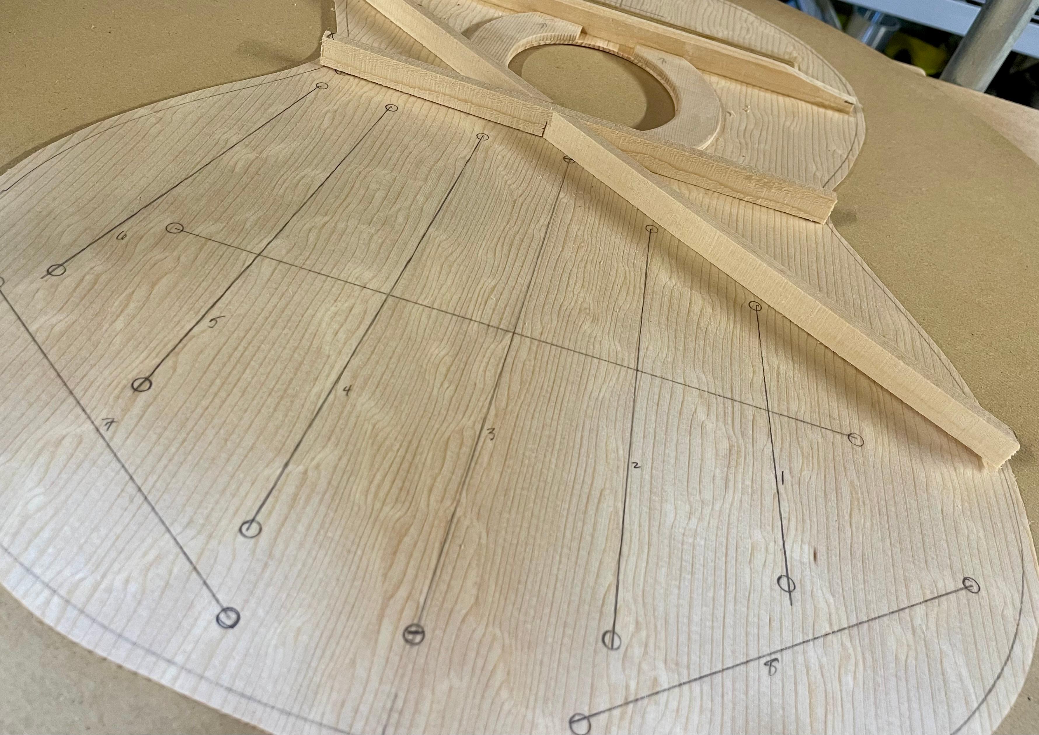 A soundboard with bracing layout marked out before carving.