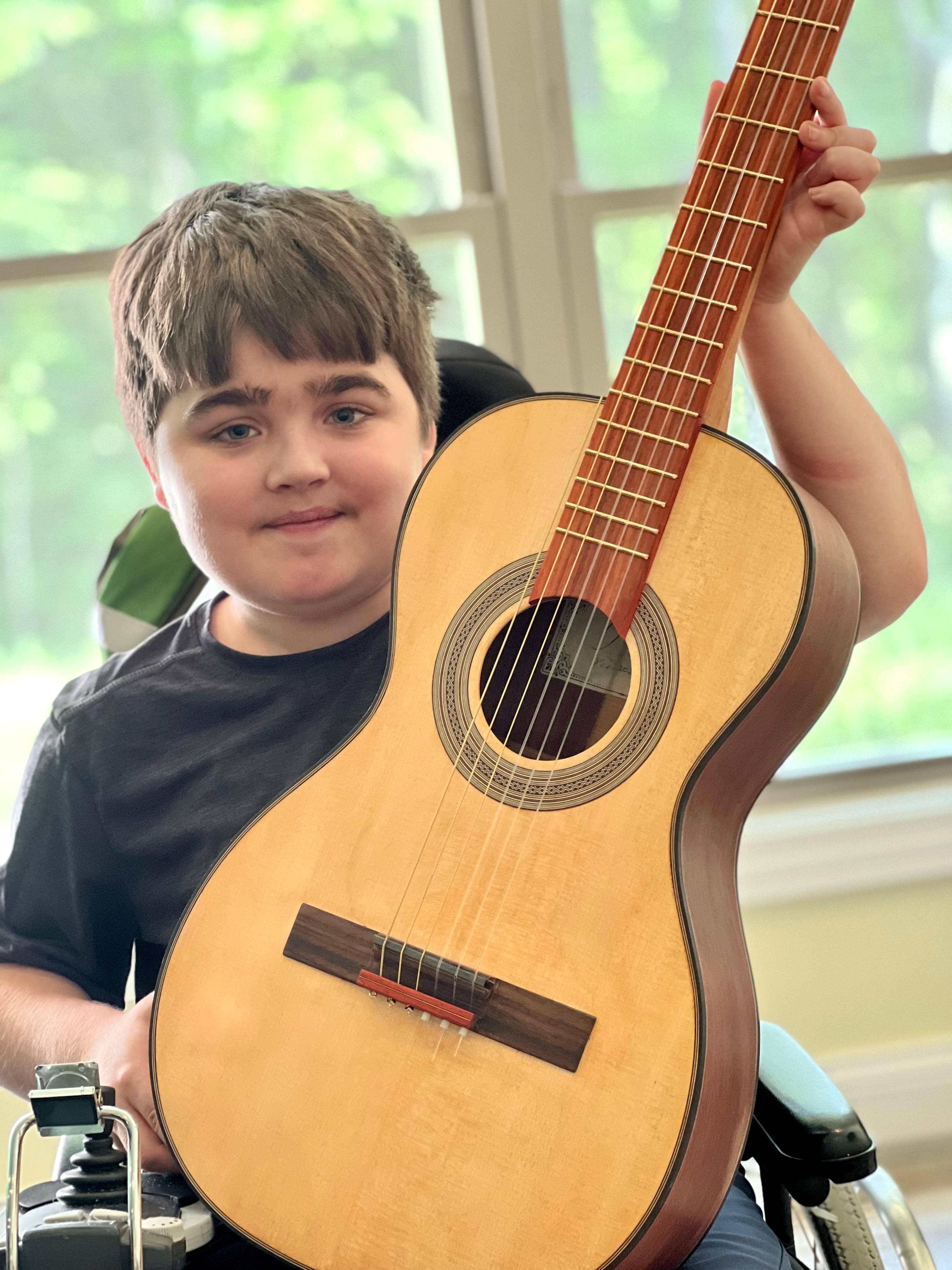 A young musician with a SugarTree parlor guitar.
